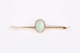 A Victorian 15ct gold and opal bar brooch, set with oval opal on a plain bar. 5cm long . Good