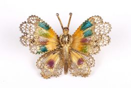 A silver gilt and enamel filigree butterfly brooch, the wings decorated with brightly coloured