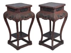 A pair of Japanese cinnabar lacquer jardiniere stands, with carved relief decoration of birds,