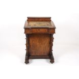 A Victorian walnut veneered davenport, of typical form, with satinwood crossbanding, the lift up top