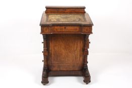 A Victorian walnut veneered davenport, of typical form, with satinwood crossbanding, the lift up top