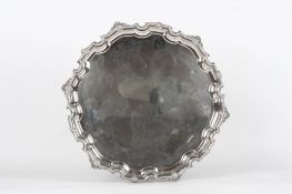 A large silver pie crust salver, hallmarked Sheffield 1961, with beaded and shell moulded rim,