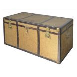 A large beige and brown travelling trunk, with three brass locks opening to reveal an upper