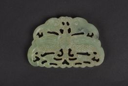 A jade coloured carved pendant, with pierced and carved design on one side, width 8.5cm . In good