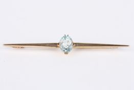 A 9ct gold and aquamarine bar brooch, with an oval claw-set aquamarine on a tapering bar, stamped