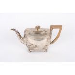 A silver bachelors teapot, hallmarked London 1884, of squat form with reeded borders, wooden