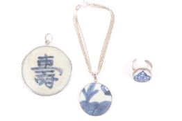 Three Chinese blue and white pottery fragments mounted as jewellery, two mounted in silver