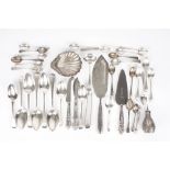 A collection of assorted silverware, including flatware, fish servers, silver scallop shell scent