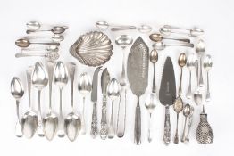 A collection of assorted silverware, including flatware, fish servers, silver scallop shell scent