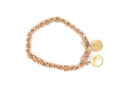 An Eastern gold coloured metal fancy link bracelet, with two small coins attached, unmarked, 35.4g .