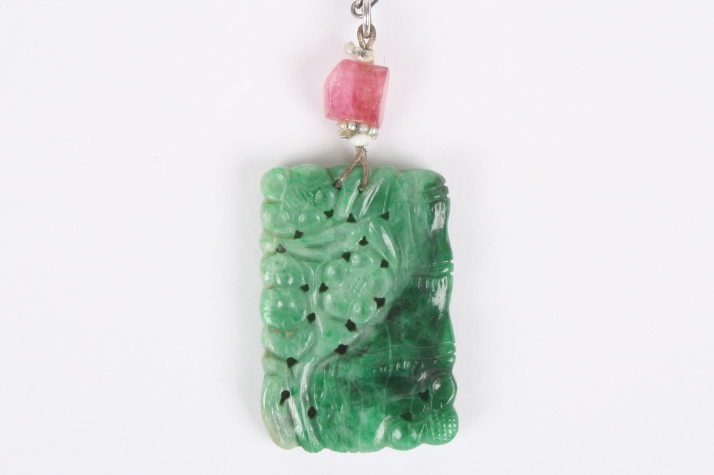 A Chinese jade pendant, of rectangular form carved on both sides with bamboo and flowers, the jade