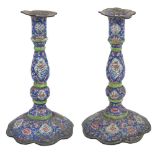 A pair of late 19th century Canton enamel candlesticks, decorated with flower panels and lotus