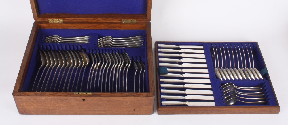 A German white metal canteen of cutlery, comprising: 11 dessert spoons, 12 dessert knives, 12