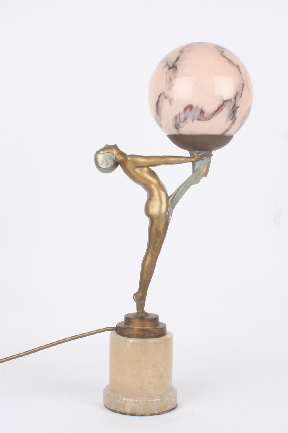 An Art Deco spelter figural lamp, of a nude woman holding aloft a single light and supported on an
