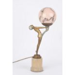 An Art Deco spelter figural lamp, of a nude woman holding aloft a single light and supported on an