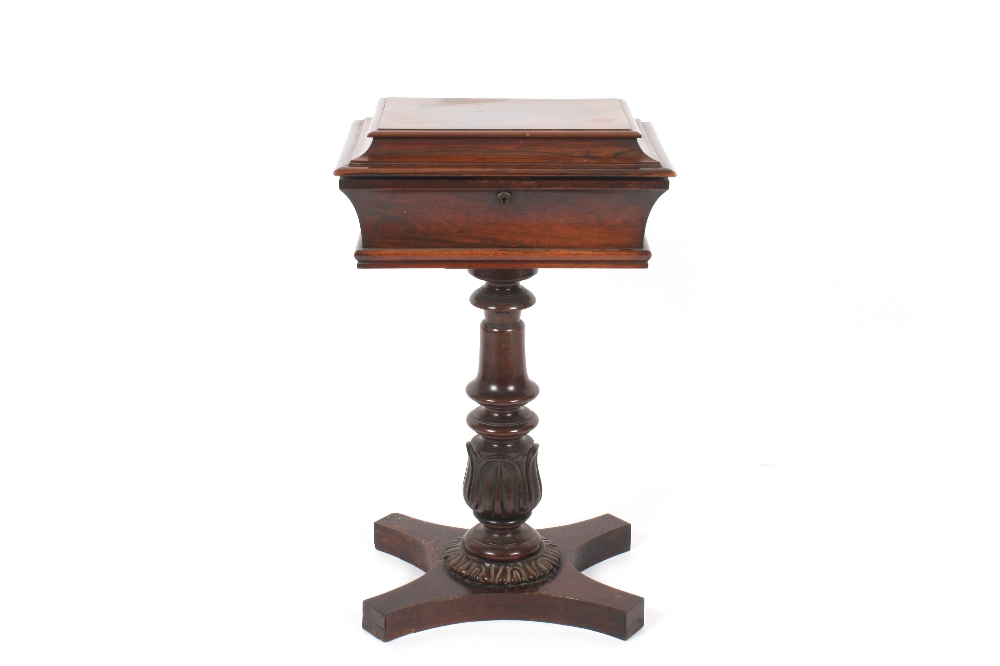 A Regency rosewood tea caddy on stand, of sarcophagus form opening to reveal a well for mixing