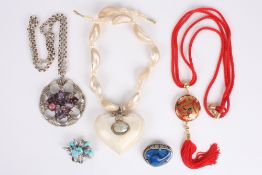 A collection of costume jewellery, including a shell necklace with a large shell pendant in the form