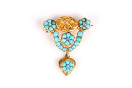 A turquoise and yellow metal brooch, formed a central knot surrounded by turquoise roundels, with