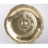 An early 20th century Indian large brass tray, decorated with a central roundel of an elephant
