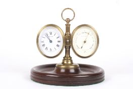 A barometer and clock desk piece, the oval shaped clock and brass aneroid barometer mounted onto a