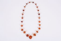 An amber bead necklace, possibly English, late 19th century with graduated faceted beads on gilt