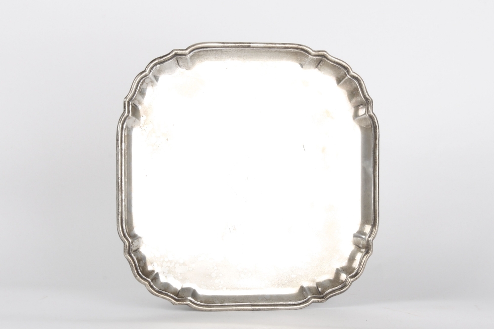An Edwardian silver salver, hallmarked London 1908, of cushion shape with moulded rolled rim. With