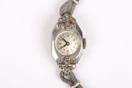 A ladies Art Deco platinum and diamond cocktail watch, with silvered dial, set within a platinum