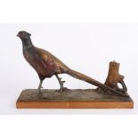 An early 20th century cold painted spelter pheasant table lighter, formed as strutting pheasant on a