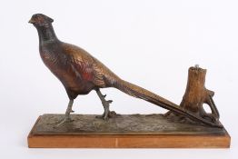 An early 20th century cold painted spelter pheasant table lighter, formed as strutting pheasant on a