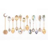 A small collection of twelve souvenir teaspoons, some with enamel decoration .