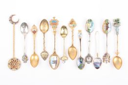 A small collection of twelve souvenir teaspoons, some with enamel decoration .