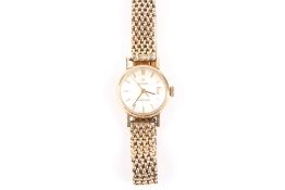 A ladies 9ct gold Omega wristwatch, with baton numerals and mesh chain bracelet . Appears to be in