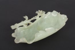 A carved jade tray or dish, probably Chinese, early 20th century of rectangular form, with carved