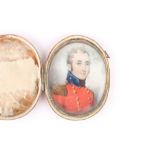 A 19th century oval miniature on ivory of an English Army officer, in red uniform, contained