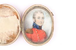 A 19th century oval miniature on ivory of an English Army officer, in red uniform, contained