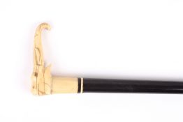 An ebony and ivory walking cane with elephant head, late 19th century the ebony shaft terminating in