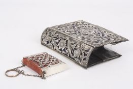 A miniature Common Prayer book contained within a fitted silver case, the pierced silver case