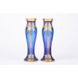 A pair of Art Nouveau glass vases, the royal blue coloured vases with gilt painted tube lined