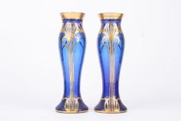 A pair of Art Nouveau glass vases, the royal blue coloured vases with gilt painted tube lined