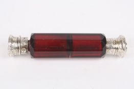 A Victorian double ended perfume bottle, the faceted cranberry coloured glass bottle with silver