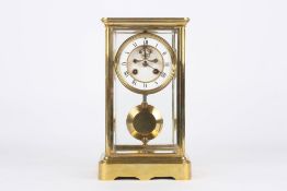 A Victorian French ormolu eight day four glass mantel clock, circa 1890, with white enamel dial