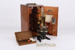 An E. Leitz Wetzlar monocular microscope, German, early 20th century No 97512, with rack and