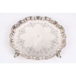 A George V silver pie crust salver, hallmarked London 1925, with engraved shell and scroll