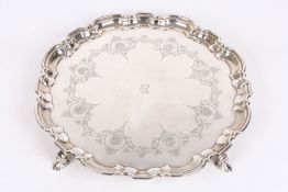 A George V silver pie crust salver, hallmarked London 1925, with engraved shell and scroll