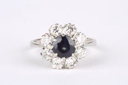 A sapphire and diamond cluster ring, set with central sapphire and surrounded by eight diamonds of