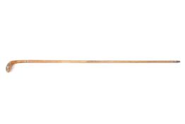 An early 20th century carved wooden ‘Sunday Stick’, formed in the shape of a golf club, with