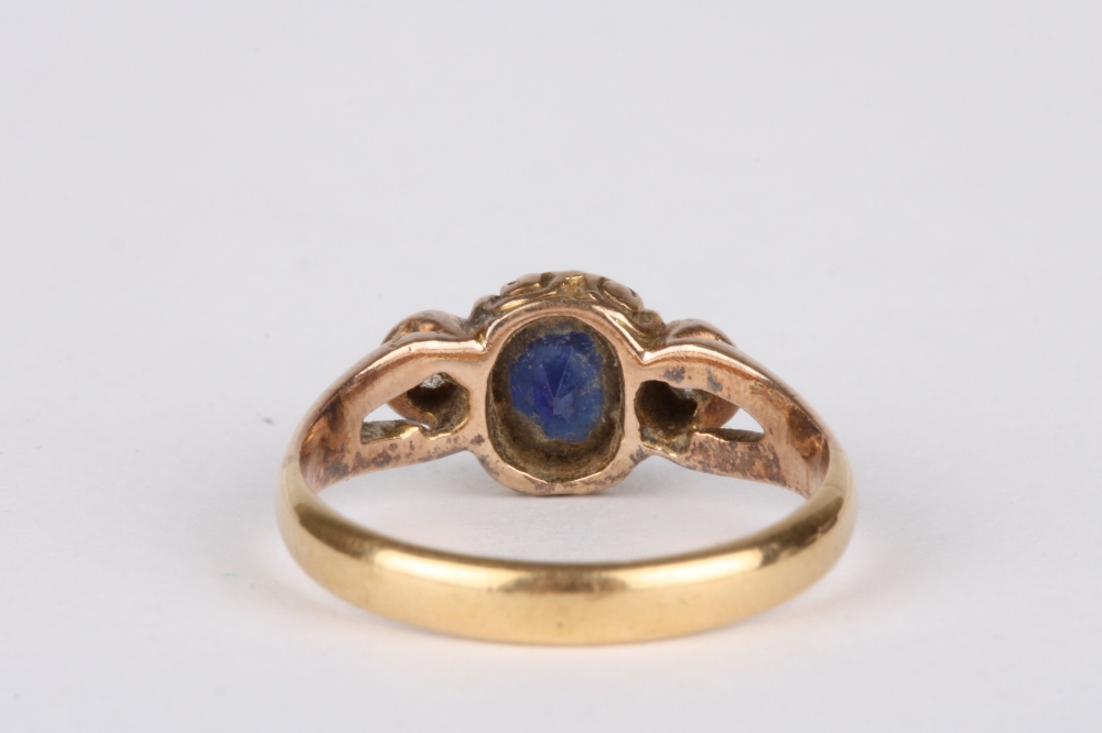 An 18ct gold, sapphire and diamond ring, set with oval sapphire flanked either side by a diamond - Image 2 of 2