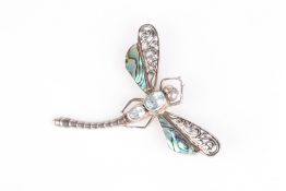 A Continental dragonfly brooch with abalone shell wings, and pale blue stone inset body, set in