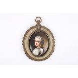 A 19th century porcelain miniature portrait, of oval form, the girl painted in white robes and