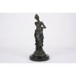 A French spelter model of a young maiden, in classical pose and flowing robes, supported on a